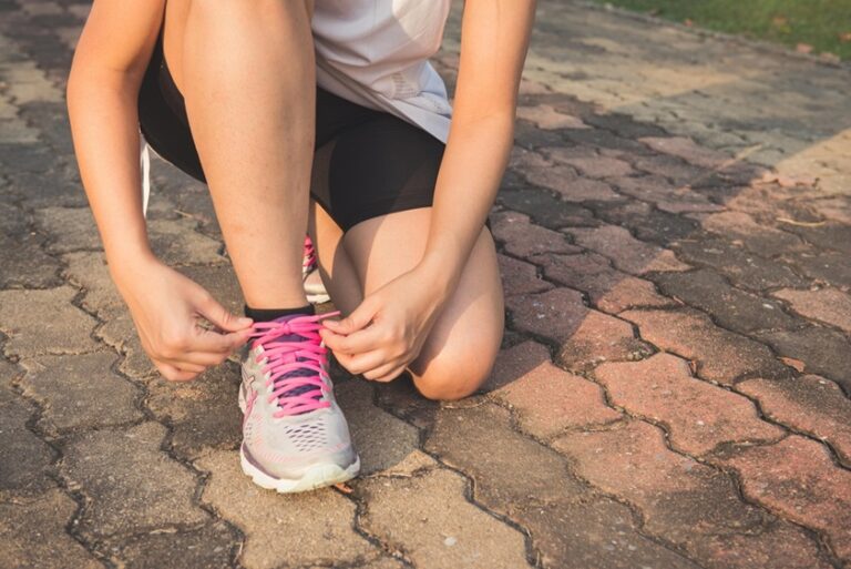 Girl tighting up her shoes ready to go running