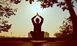 Person meditating to help reduce anxiety